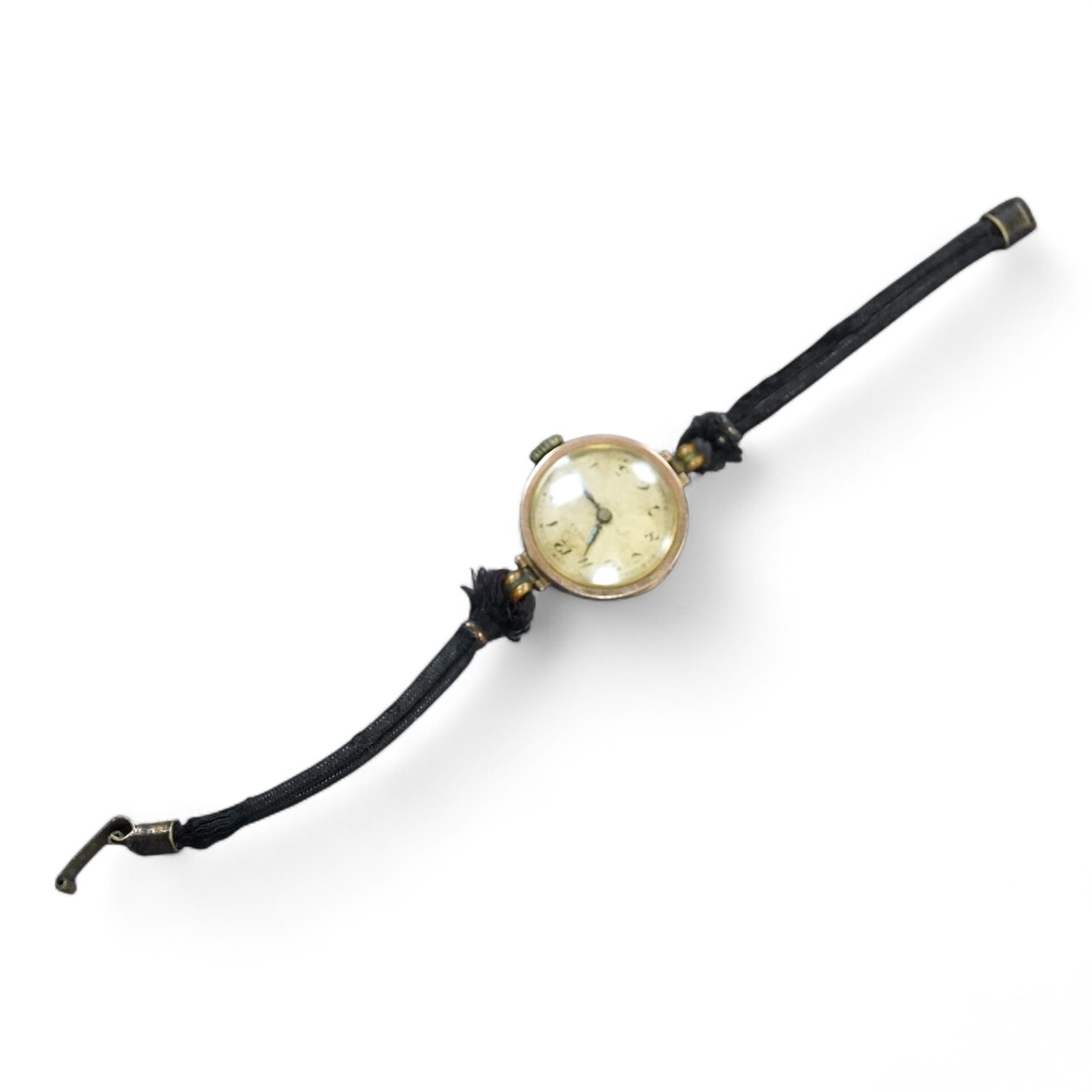 A lady's 1920's 9ct gold manual wind wrist watch, sunburst Arabic dial, case diameter 23mm, on and associated fabric strap.